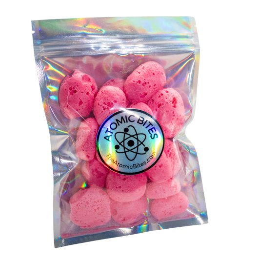 freeze dried cherry laffy taffy rope in a mylar holographic bag, round pieces that are light red. Atomic Bites sticker theatomicbites.com